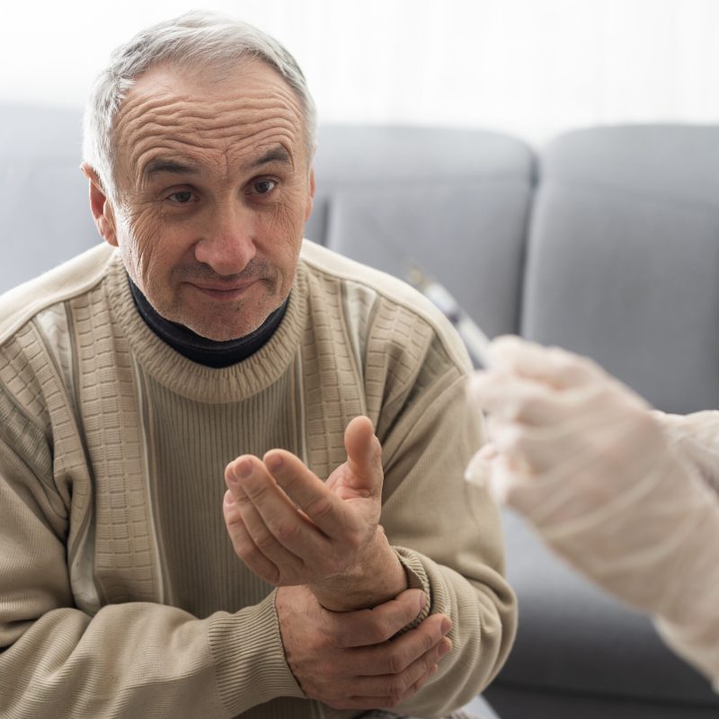 Doctor giving vaccination shot to elderly patient by syringe or injunction at home. concept of home health check to seniors during coronavirus covid-19 pandemic Doctor giving vaccination shot to elderly patient by syringe or injunction at home. concept of home health check to seniors during coronavirus covid-19 pandemic.